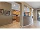 View of the kitchen with tile floors, breakfast bar, and pass-through to the living area at 19714 N Rim Dr, Surprise, AZ 85374