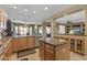 Open kitchen features granite countertops, wooden cabinets, and access to the dining area at 19714 N Rim Dr, Surprise, AZ 85374