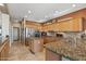 Updated kitchen features granite countertops, stainless appliances, and large center island at 19714 N Rim Dr, Surprise, AZ 85374