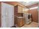 Laundry room complete with sink, cabinetry, and white washer and dryer units at 19714 N Rim Dr, Surprise, AZ 85374