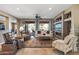 Spacious living room with large windows, a ceiling fan, tile floors, and comfortable seating at 19714 N Rim Dr, Surprise, AZ 85374
