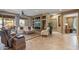Stylish living room with custom built-ins, neutral tones, and seamless transition to other living spaces at 19714 N Rim Dr, Surprise, AZ 85374