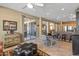 Open-concept living room and kitchen with tile floors, sliding glass doors, and a modern ceiling fan at 19714 N Rim Dr, Surprise, AZ 85374