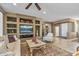 Stylish living room with custom built-ins, neutral tones, and seamless transition to other living spaces at 19714 N Rim Dr, Surprise, AZ 85374