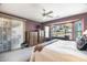 Main bedroom with a large window, light carpet, and ceiling fan at 19714 N Rim Dr, Surprise, AZ 85374