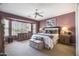 Main bedroom with a large window, dresser, lamps, and stylish decor at 19714 N Rim Dr, Surprise, AZ 85374