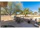 Spacious patio with a built-in grill, dining table, and serene desert landscape, ideal for outdoor entertaining at 19714 N Rim Dr, Surprise, AZ 85374