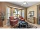 Sitting area has chairs, bay window, ceiling fan and natural light at 19714 N Rim Dr, Surprise, AZ 85374