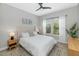 Bright bedroom with a queen bed, ceiling fan, and shuttered windows for natural light at 20121 N 76Th St # 1019, Scottsdale, AZ 85255