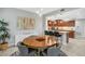 Dining room features a wooden table with seating and is open to the modern kitchen at 20121 N 76Th St # 1019, Scottsdale, AZ 85255