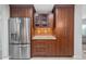 Kitchen featuring stainless steel refrigerator and updated wood cabinets with granite countertops at 20121 N 76Th St # 1019, Scottsdale, AZ 85255
