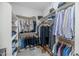Organized walk-in closet with ample hanging and shelving space for clothes and accessories at 20121 N 76Th St # 1019, Scottsdale, AZ 85255