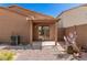 View of the back patio and landscaping, including cacti, rock bed and covered patio at 2024 E Dust Devil Dr, San Tan Valley, AZ 85143