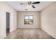 Bright bedroom featuring a ceiling fan, a closet, wood floors, and a window with a view at 2024 E Dust Devil Dr, San Tan Valley, AZ 85143