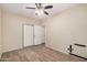 Bedroom with a ceiling fan, closet, and wood flooring at 2024 E Dust Devil Dr, San Tan Valley, AZ 85143