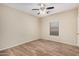 Cozy bedroom featuring wood-style flooring, a ceiling fan, and a window at 2024 E Dust Devil Dr, San Tan Valley, AZ 85143
