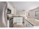Modern kitchen with stainless steel appliances, granite countertops, and white cabinetry at 2024 E Dust Devil Dr, San Tan Valley, AZ 85143