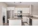 Well-lit kitchen featuring white cabinets, granite countertops, and stainless appliances at 2024 E Dust Devil Dr, San Tan Valley, AZ 85143