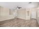 Open living area with wood-look tile flooring, fan and neutral paint at 2024 E Dust Devil Dr, San Tan Valley, AZ 85143