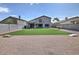 Backyard with artificial turf, desert landscaping and outdoor seating area at 20638 N 11Th St, Phoenix, AZ 85024