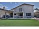 Spacious backyard with artificial turf, covered patio, and outdoor seating area at 20638 N 11Th St, Phoenix, AZ 85024