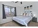 Sunlit bedroom featuring a large window, a ceiling fan, and a comfortable bed at 20638 N 11Th St, Phoenix, AZ 85024