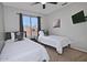 Cozy bedroom featuring two twin beds, a ceiling fan, and a window view at 20638 N 11Th St, Phoenix, AZ 85024