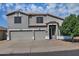 Two-story home with a three-car garage, neutral paint, and desert landscaping at 20638 N 11Th St, Phoenix, AZ 85024