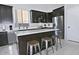 Modern kitchen with stainless steel appliances, stylish island with bar stools, and ample counter space at 20638 N 11Th St, Phoenix, AZ 85024