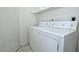 Efficient laundry room with standard-sized washer and dryer, and shelf for linens at 20638 N 11Th St, Phoenix, AZ 85024