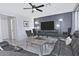 Bright living room with large TV, modern decor, and comfortable leather seating at 20638 N 11Th St, Phoenix, AZ 85024