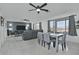 Open living room with a ceiling fan, dining table, and large windows offering ample natural light at 20638 N 11Th St, Phoenix, AZ 85024