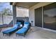 Covered patio featuring lounge chairs with blue cushions, perfect for outdoor relaxation at 20638 N 11Th St, Phoenix, AZ 85024