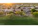 Beautiful aerial view of homes and golf course featuring sunset light across the upscale community at 22231 N 55Th St, Phoenix, AZ 85054