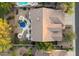 Aerial view of a private backyard with a pool and desert landscaping, showcasing the home's roof and surrounding area at 22231 N 55Th St, Phoenix, AZ 85054