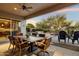 Inviting outdoor patio features comfortable seating, a dining table, and serene views of the lush backyard at 22231 N 55Th St, Phoenix, AZ 85054