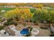 Stunning backyard view showcasing a sparkling pool, scenic green landscaping, and a charming firepit area at 22231 N 55Th St, Phoenix, AZ 85054