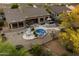 Aerial view showcases a pool, covered patio, and firepit, perfect for outdoor enjoyment and relaxation at 22231 N 55Th St, Phoenix, AZ 85054