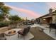 Enjoy this desert backyard with a pool, firepit, outdoor bar and mature plants at 22231 N 55Th St, Phoenix, AZ 85054