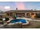 Spacious backyard with a pool, lush landscaping, and outdoor seating area at 22231 N 55Th St, Phoenix, AZ 85054