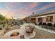 Lush backyard with a pool, fire pit, desert landscaping, and patio at 22231 N 55Th St, Phoenix, AZ 85054