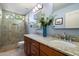 Bright bathroom featuring a walk-in shower, double vanity, and granite countertops at 22231 N 55Th St, Phoenix, AZ 85054