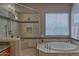 Relaxing bathroom featuring a soaking tub, tiled shower, and neutral tones for a spa-like experience at 22231 N 55Th St, Phoenix, AZ 85054