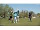Golfers celebrating on a sunny day at the golf course, surrounded by lush greenery and desert landscape at 22231 N 55Th St, Phoenix, AZ 85054