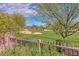 Picturesque golf course view from home featuring lush greenery, sand traps, and blue skies in the distance at 22231 N 55Th St, Phoenix, AZ 85054