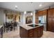 Modern kitchen featuring a central island, stainless steel appliances, and seamless access to the dining and living areas at 22231 N 55Th St, Phoenix, AZ 85054