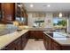 Beautiful kitchen featuring custom cabinetry, stone countertops, tile backsplash and an island cooktop at 22231 N 55Th St, Phoenix, AZ 85054