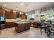 Spacious kitchen featuring custom wood cabinetry, a large island, and stainless steel appliances for a gourmet experience at 22231 N 55Th St, Phoenix, AZ 85054