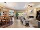 Inviting living area with tile floors, fireplace, large windows, comfortable seating and a view into the kitchen at 22231 N 55Th St, Phoenix, AZ 85054