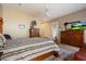 Comfortable bedroom featuring wood floors, an area rug, a ceiling fan, and a TV at 22231 N 55Th St, Phoenix, AZ 85054